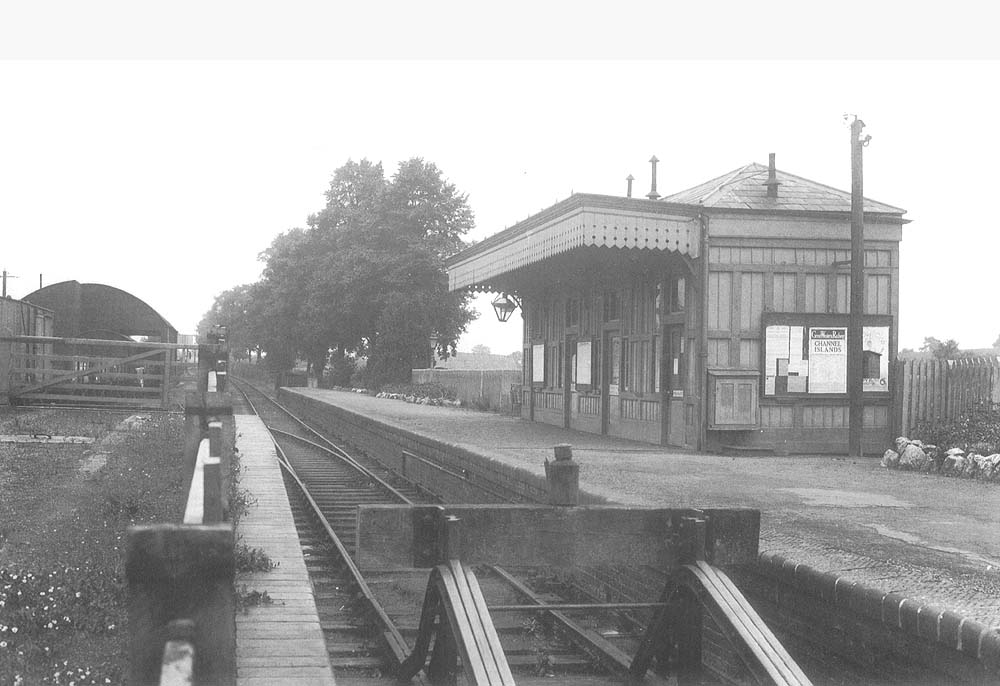 Looking along the platform towards Moreton-in-Marsh with the goods shed on the left and the timber constructed station building on the right