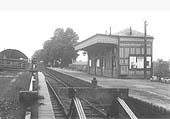 Looking along the platform towards Moreton-in-Marsh with the goods shed on the left and the timber constructed station building on the right