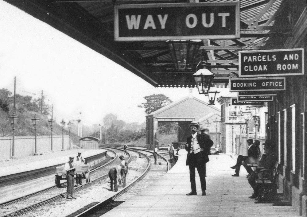 Close up showing the Permanent Way gang working on both sets of tracks and the goods yard which was located at the end of the down platform