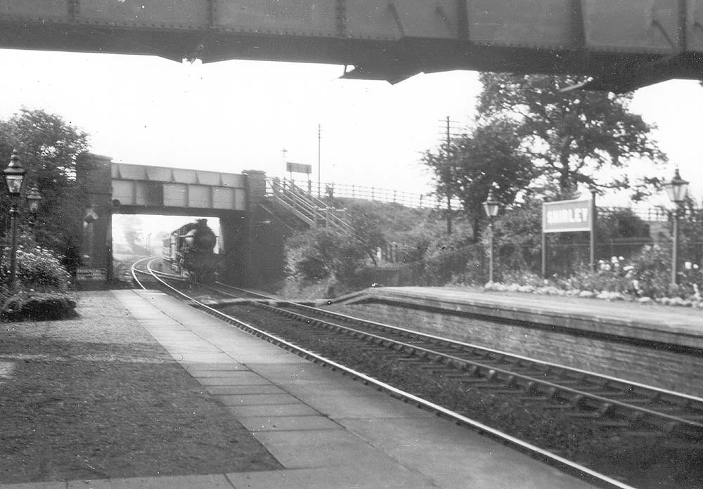 GWR 4-4-0 County class No 3816 'County of Leicester' is seen on an up express to Birmingham as it passes under Haslucks Green bridge