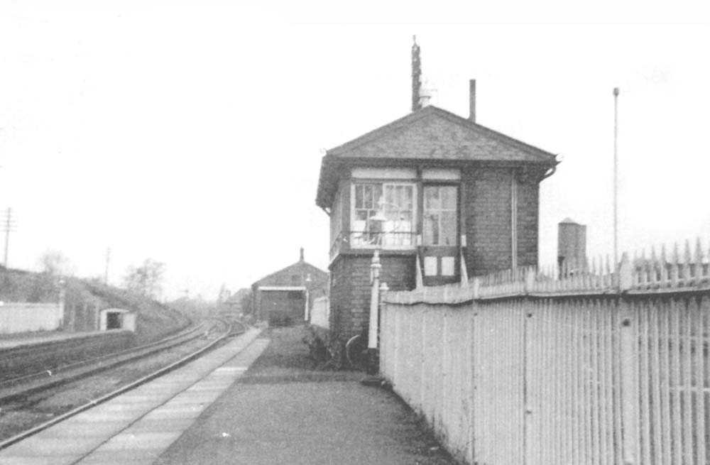 Looking towards Birmingham with Shirley station's signal box in the foreground, the goods shed in the distance and on the up side, the platelayer's hut
