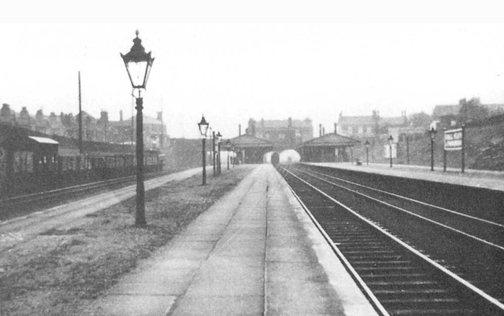 View of Small Heath and Sparkbrook station after quadrupling along the up relief platform whilst a train from Moor Street is arriving in the distance