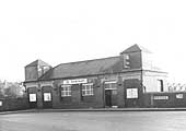 View of Small Heath station's booking office situated on the bridge of Golden Hillock Road with just one exterior door in use