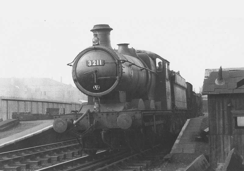 British Railways 49xx (modified Hall) class 4-6-0 No 6992 Aborfield Hall with an express passes Soho and Winson Green Station on the up relief line