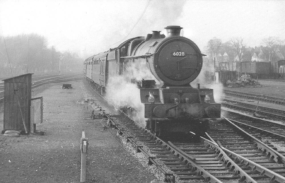 GWR 4-6-0 No 6028 'King George VI' is seen at the head of an up express service entering Solihull station's on the Up Main line