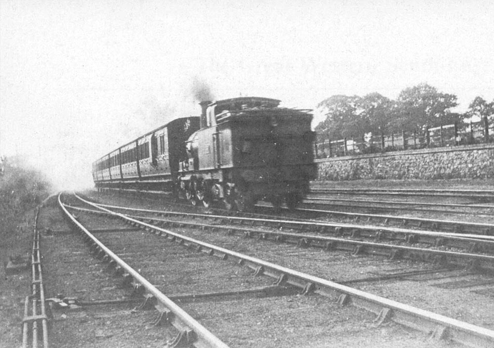 An unknown GWR 0-4-4T 3521 Class locomotive is seen running bunker first on a Snow Hill to Stratford local service