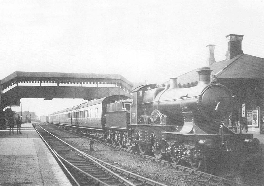 GWR 4-4-0 Bulldog Class No 3393 'Australia' stands at Solihull's extended up platform in Edwardian days