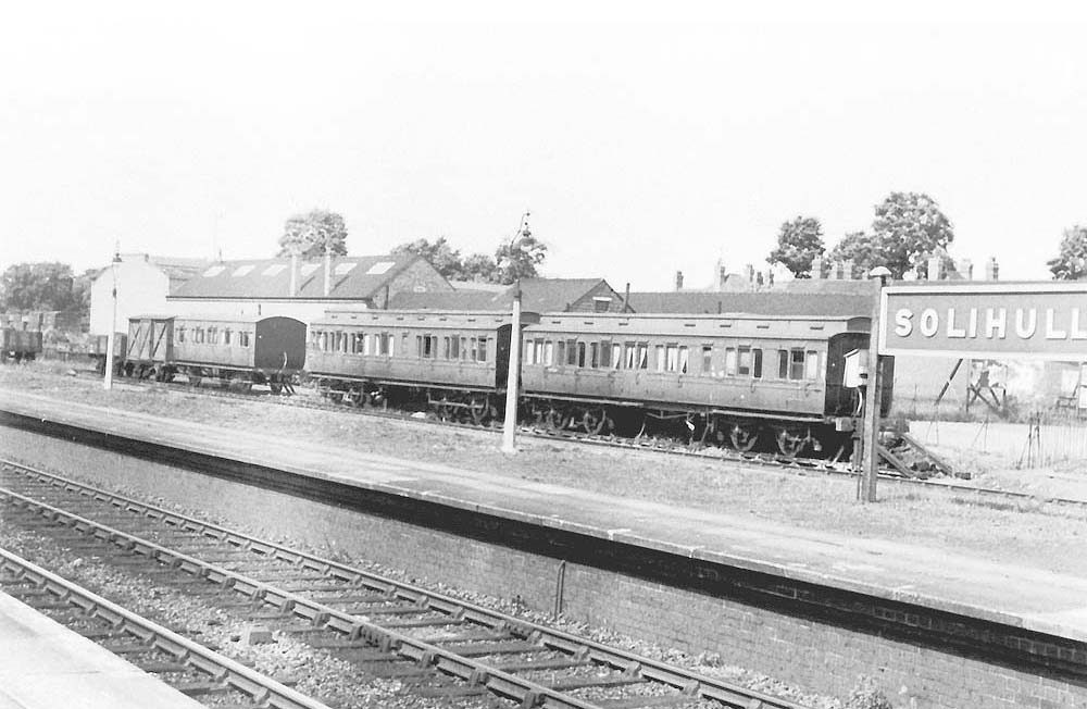 Behind the main island platform, three departmental coaches are stabled in the up sidings at the north end of Solihull station
