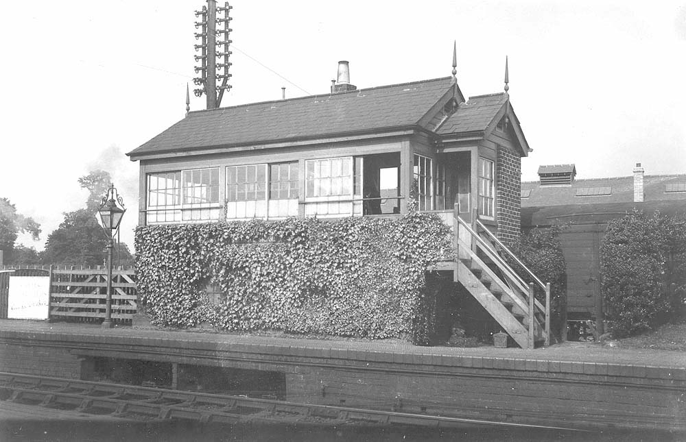 View of the original signal box shortly before its demolition with the old goods shed and yard behind