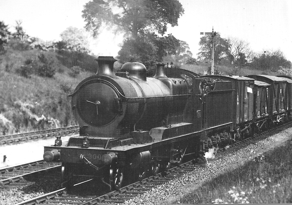 GWR 2-8-0 30xx 'ROD' class No 3001 steams past Southam Road station with a Class H through freight train