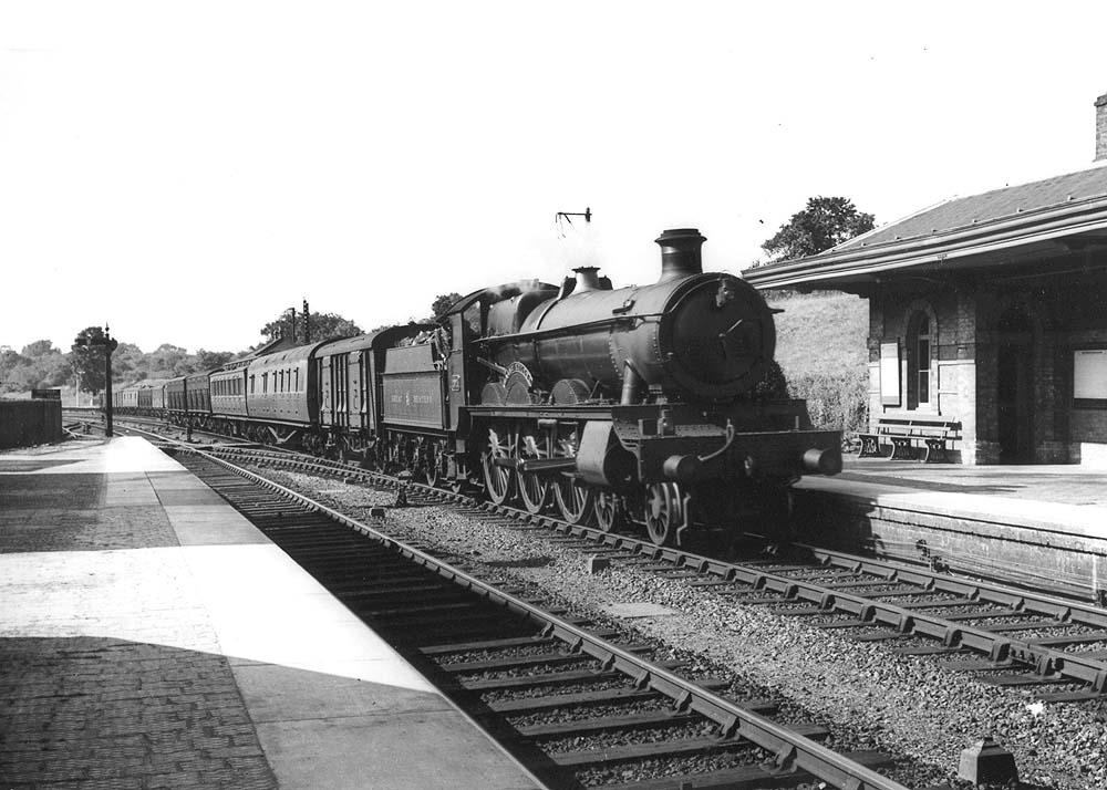 GWR 4-6-0 No 2924 'Saint Helena' is seen leaving the up refuge siding with a long empty mixed stock train in 1936