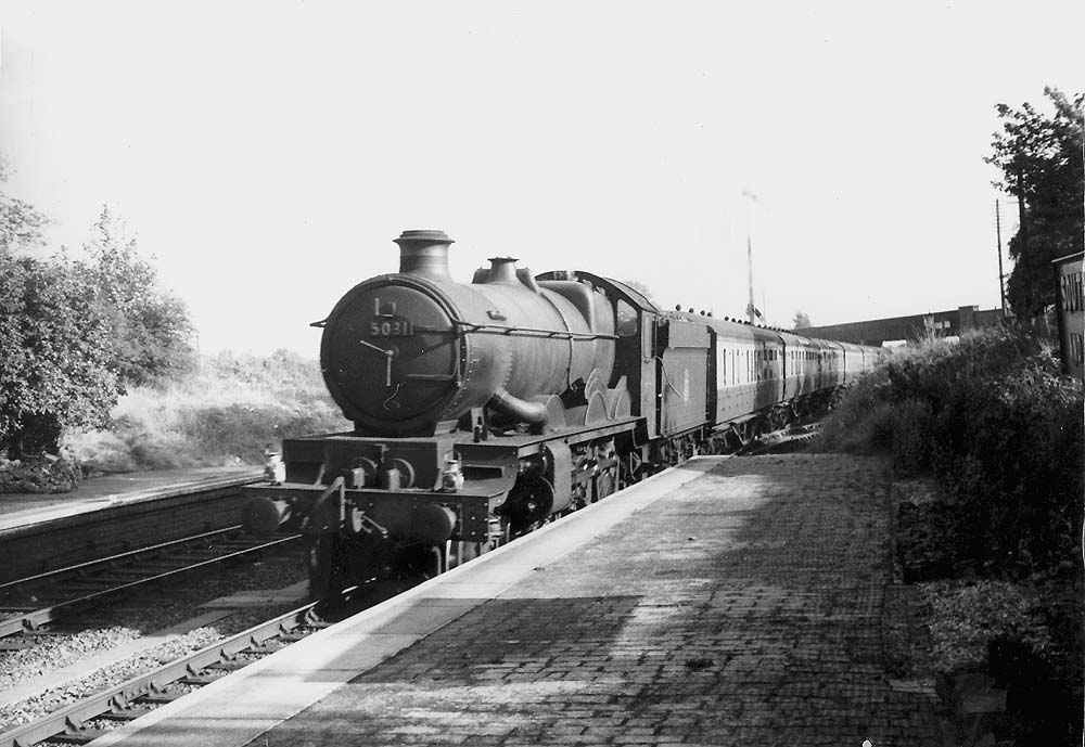 GWR 4-6-0 No 5031 'Totness Castle' is seen passing the station on a down Paddington to Birkenhead express