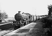 GWR 4-6-0 No 5031 'Totness Castle' is seen passing the station on a down Paddington to Birkenhead express