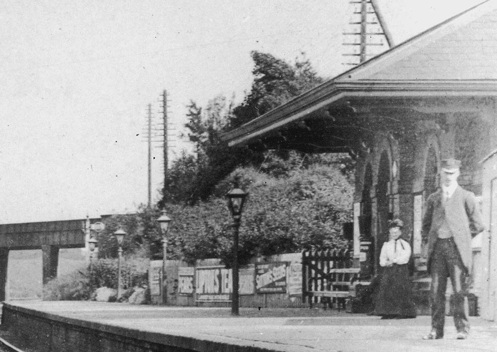 Close up showing the up platform at Southam and Harbury together with passengers and facilities 