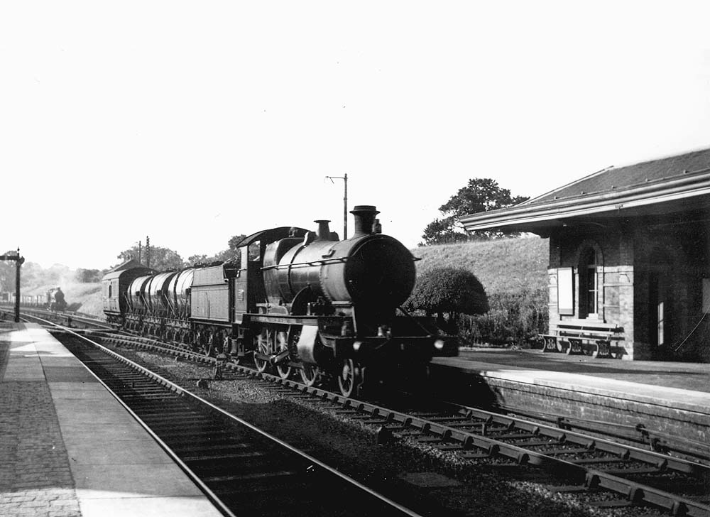 GWR 2-6-0 Mogul No 5385 is seen passing through the station on an up short train of three six-wheel milk tank wagons