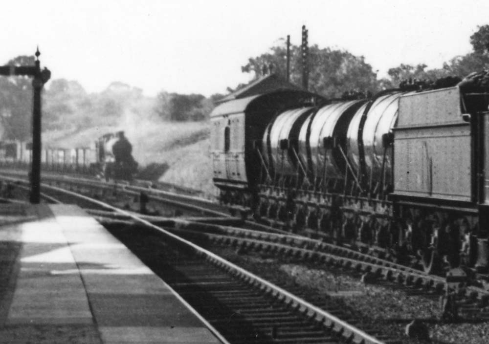 Close up showing an up goods waiting in the refuge siding for the right of way after the milk train has passed