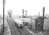 An unidentified GWR Diesel Railcar is seen passing Stratford on Avon West Signal Box on the up 9:10am  Cardiff to Snow Hill service