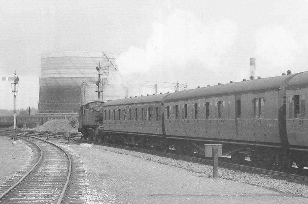 An unidentified ex-GWR 2-6-2T 51xx class locomotive is seen running bunker first on a local passenger service to Birmingham in 1957