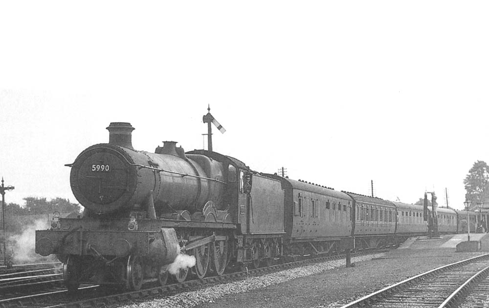 Ex-GWR 4-6-0 Hall class No 5990 'Dorford Hall' is seen departing Stratford on Avon on the 9:35am Swansea to Wolverhampton service