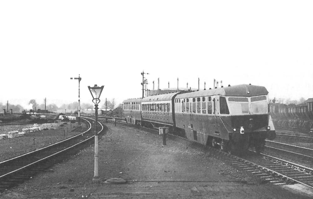 GWR Diesel Railcars W37 W and W38 W are seen with a Third class coach in between departing on the up 5:05pm Cardiff to Birmingham service