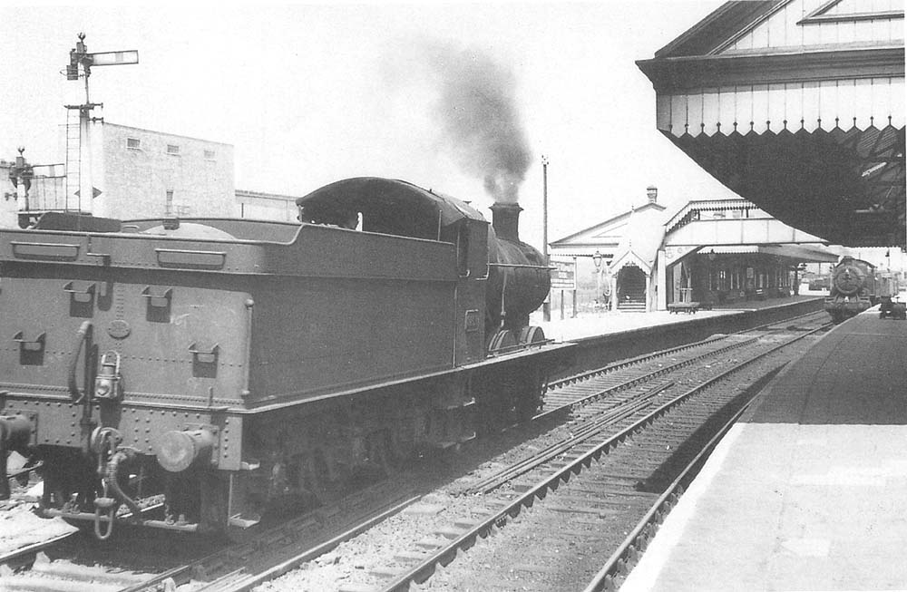 Ex-GWR 0-6-0 2251 class No 2238 is seen coasting through the station on the up main in preparation for another banking duty in the early 1950s