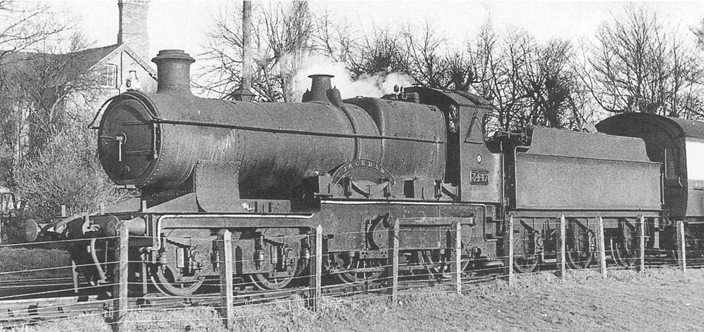 Ex-GWR 4-4-0 Bulldog class No 3447 'Jackdaw' is seen in the up refuge siding at the head of empty stock ready to take forward a local passenger service