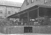 View of Flower & Sons Ltd's loading deck for barralled beer moved by road transport as seen from the main road entrance to the brewery