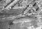 View of the throat to the sidings at Stratford on Avon station's goods yard, Flower & Sons Brewery and the local gas works