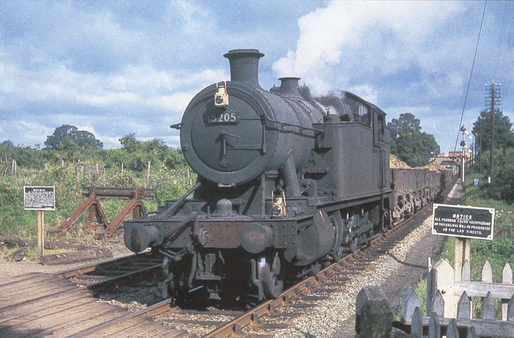 Ex-GWR 2-8-0T No 5205, first of the class, approaches Stratford upon Avon at the head of an iron ore train from Banbury during August 1962