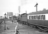 An unidentified ex-GWR 4-6-0 Hall class locomotive departs Stratford-upon-Avon with a northbound down service circa 1957
