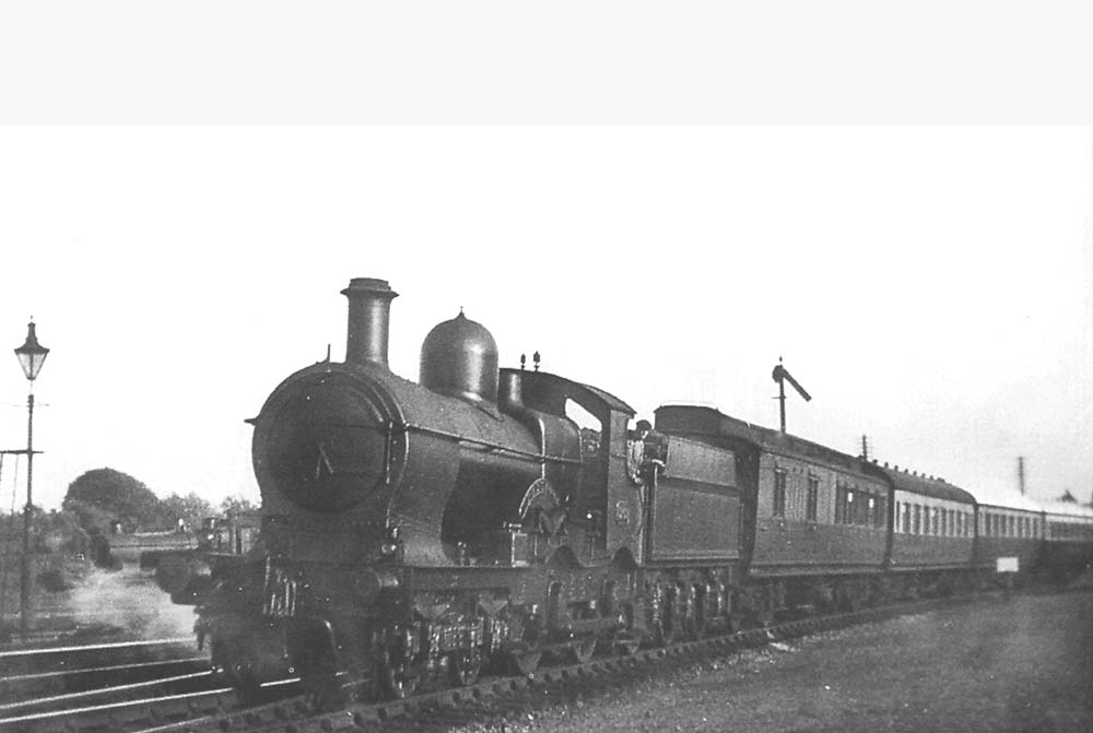 GWR 4-4-0 Duke Class No 3269 'Dartmoor' is seen leaving Stratford on Avon on a northbound train circa 1935