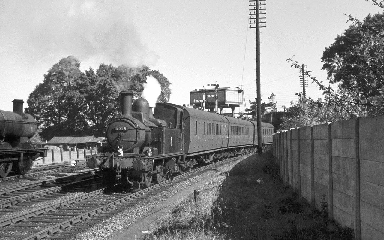 Ex-GWR 0-4-2T No 5815 is passing an ex-GWR 2251 class locomotive by the first pedestrian crossing joining Albany Road to Shottery fields on 15th June 1957
