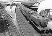 British Railways built 0-6-0PT 94xx class No 9429 is seen standing at the down platform on a three-coach local service to Honeybourne