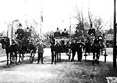 Looking towards Alcester Road along the main approach to Stratford on Avon station showing horse-drawn carriages posed outside