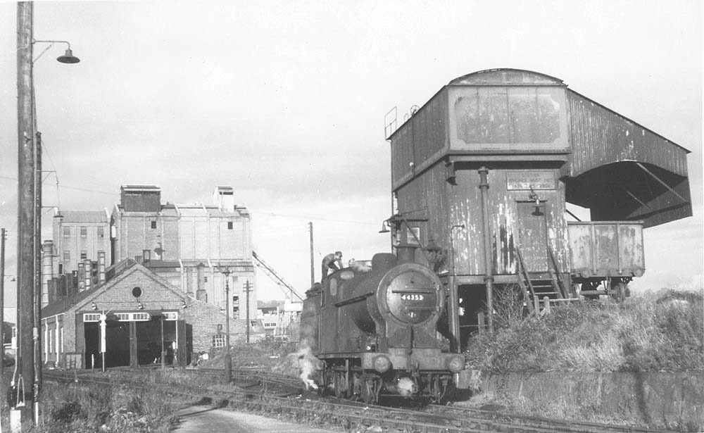 Ex-LMS 0-6-0 4F No 44353 is bearing a 2E shed plate as it stands at the GWR coaling stage for coaling and watering before returning to the SMJ