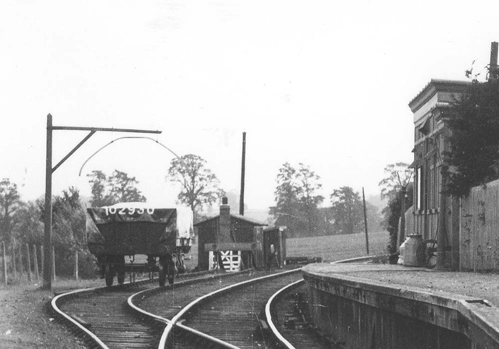 Close up showing the covered wagon standing in the siding with two platelayers huts standing behind the buffer stops