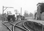 Close up showing the covered wagon standing in the siding with two platelayers huts standing behind the buffer stops