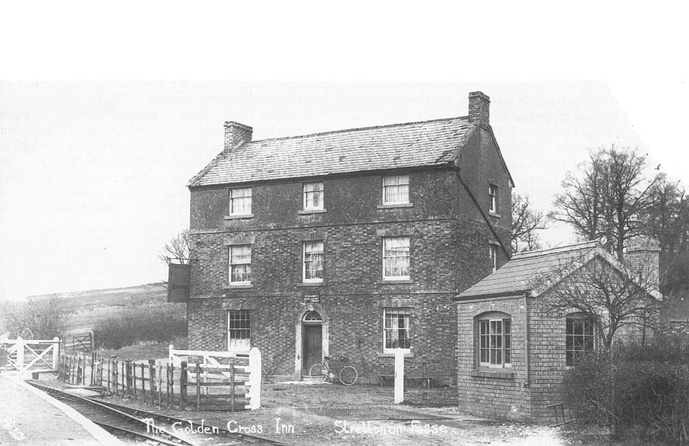 View of the weighbridge and office at the entrance of the goods yard with the Golden Cross Hotel adjacent to the station