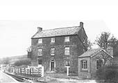 View of the weighbridge and office at the entrance of the goods yard with the Golden Cross Hotel adjacent to the station