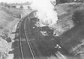 Ex-GWR 0-6-0PT No 3635 with an engineer's train comprising breakdown crane and empty open wagons circa 1964