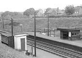 Close up showing details of the down platform passenger waiting room and the white hut on the up platform used as a ticket office