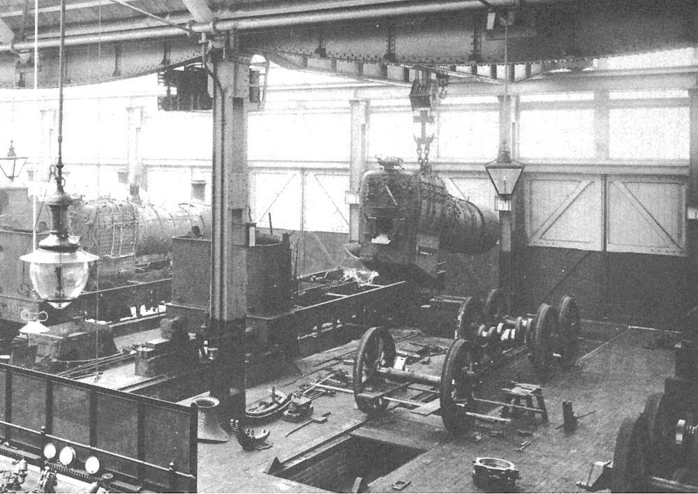 Close up showing two of the repair roads with a GWR 2-6-2T tank engine stripped down to its frame with only the bunker remaining