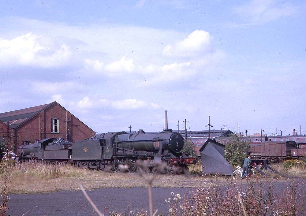Behind the two locomotive roundhouses at Tyseley shed on Wednesday 9th September 1964, rests ex-Great Western Railway 10xx (County) class No 1011 'County of Chester'
