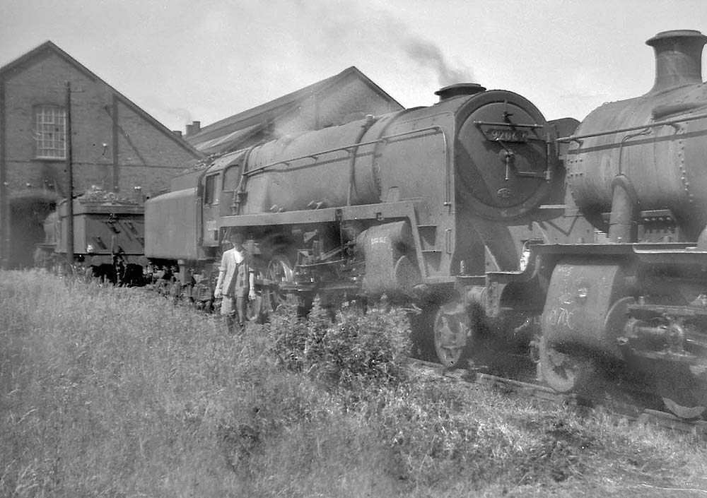 British Railways 2-10-0 Standard Class 9F No 92002 is seen in steam at the rear of Tyseley shed in 1959