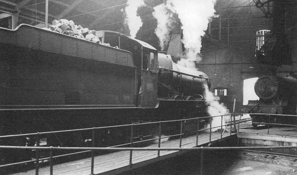 An unidentified ex-Great Western Railway 4-6-0 Grange Class locomotive is being turned inside Tyseley shed in 1964