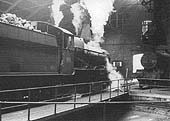 An unidentified ex-Great Western Railway 4-6-0 Grange Class locomotive is being turned inside Tyseley shed in 1964