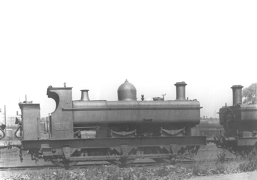 GWR 0-6-0PT No 1070 fitted with a half-cab and a member of the outside-framed 1016 class, is seen on shed on 21st June 1931