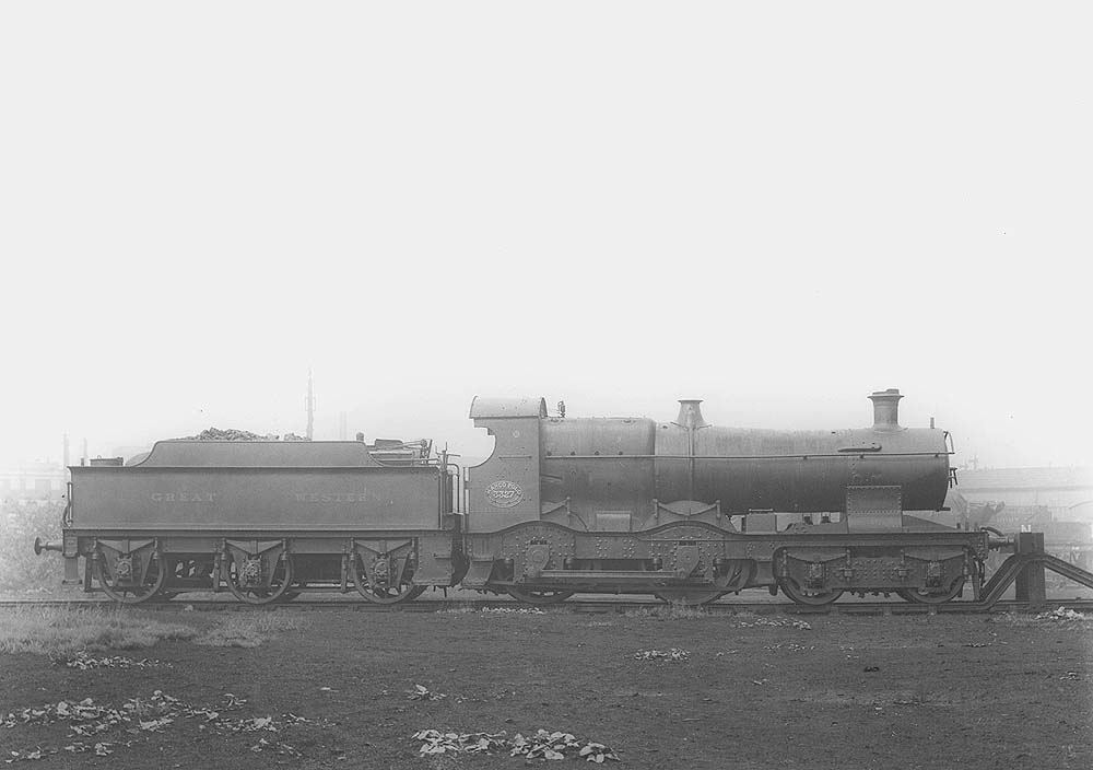 GWR 4-4-0 No 3327 'Marco Polo', a curved outside-framed Bulldog class locomotive, is seen resting against the buffers in Tyseley shed's yard