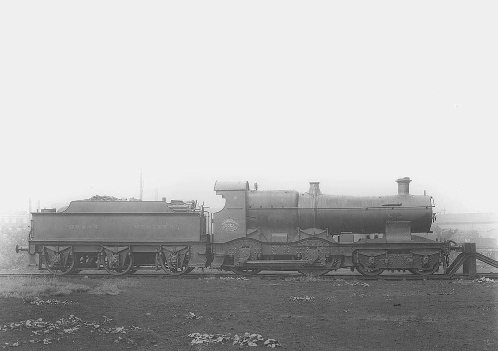 GWR 4-4-0 No 3327 'Marco Polo', a curved outside-framed Bulldog class locomotive, is seen resting against the buffers in Tyseley shed's yard