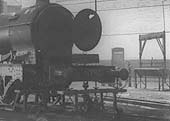 Close up of GWR 2-4-0 Barnum class No 3210 with the bufferbeam removed and supported by a rail mounted trolley tall and slim screw jacks